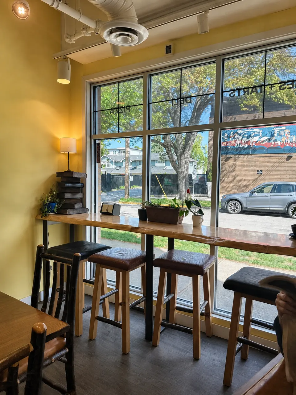 Window seats and the bright yellow interior of Bubby Rose’s on Cook Street